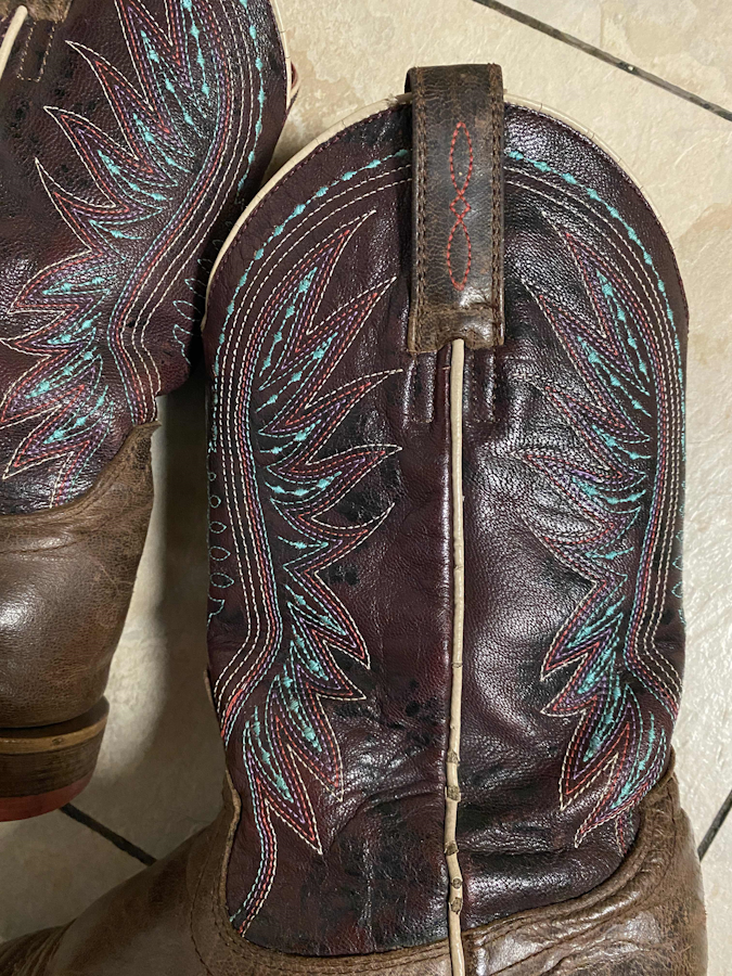 The shaft of the boots, showing the trimmed and cleaned up bootstraps as well as the trimmed embroidery.