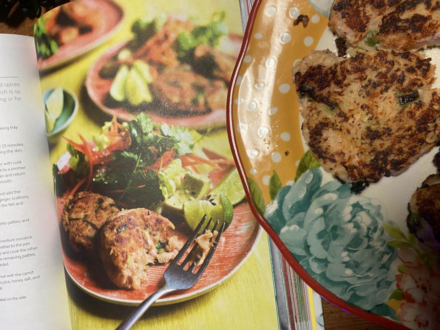 A plate of fish cakes next  to a photo of much better looking fish  cakes from the recipe book