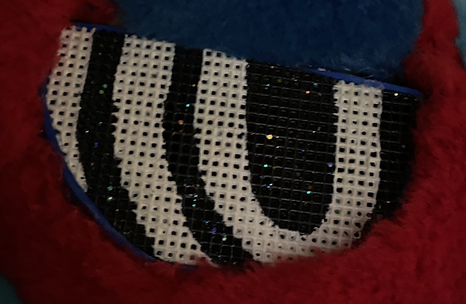 Close-up of my fursuit's eyes showing the glitter shining in its eyes.