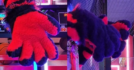 Two photos of the fursuit paws, which are short furred deep dark purple with red fur palms.