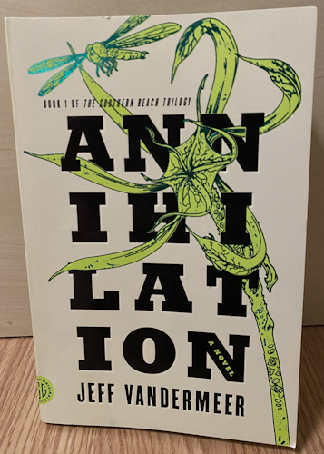 A copy of Annihilation. It's light green and has a plant growing up and around the text.