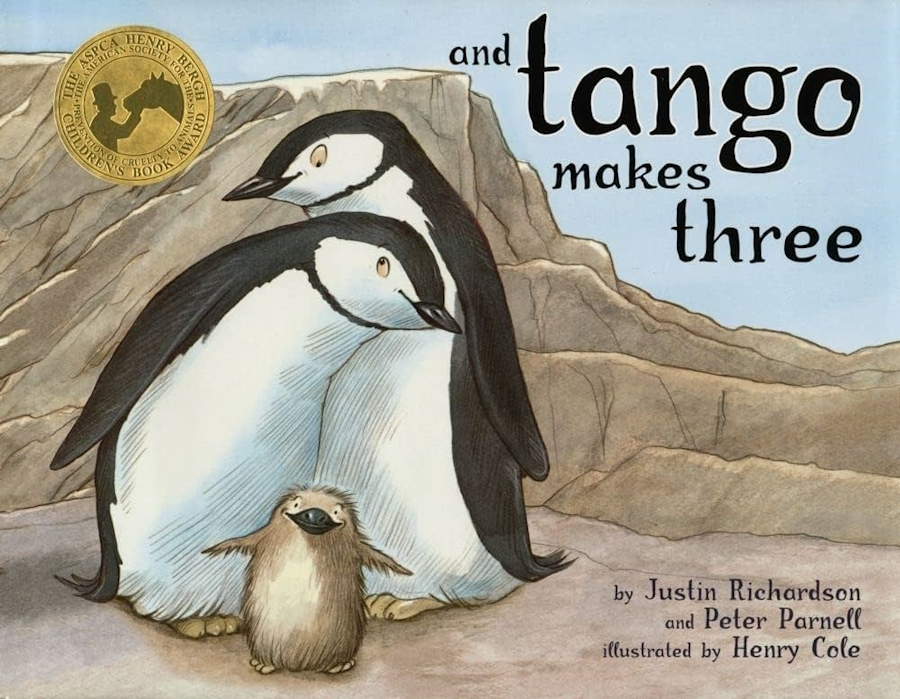 The cover of And Tango Makes Three a children's book with watercolor-like drawings of two adult penguins and a baby penguin.
